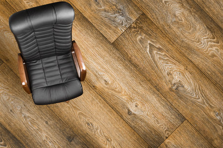 Black leather armchair on wood background. Up viewの写真素材