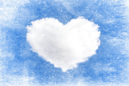 heart shape of cloud on blue sky. Grunge paper texture backgroundの写真素材