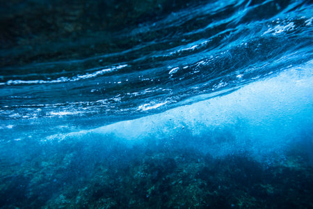 Sea bottom with blue water wave splash backgroundの写真素材