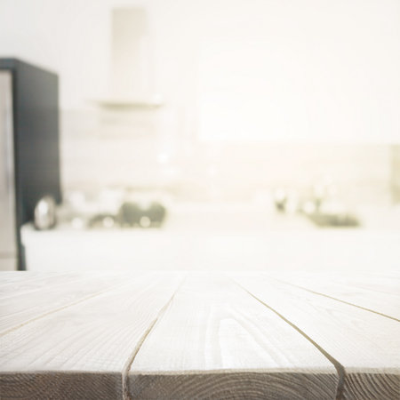 Wooden table over blured kitchen interior backgroundの写真素材