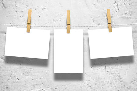 Photo frames with pins on rope over old aged brick wall backgroundの写真素材