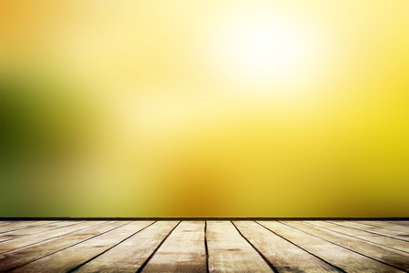 Empty wooden table with blurred autumn natural background with bokehの写真素材