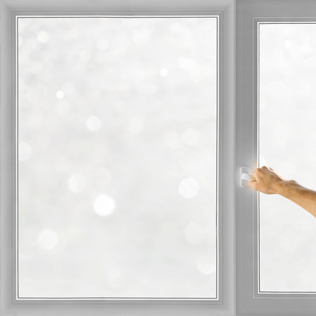 Hand open window over winter bokeh backgroundの写真素材