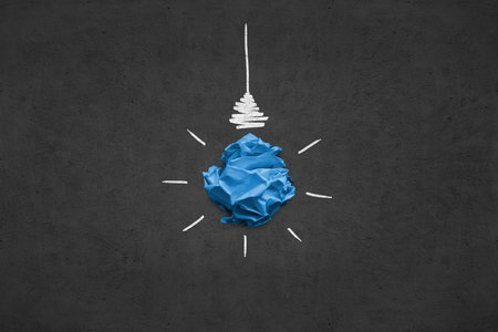 Imitation of lightbulb with cracked paper inside. Inspiration concept backgroundの写真素材