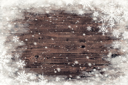The brown wood texture with snow flakes over it. Winter backgroundの写真素材