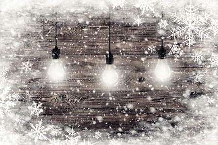 The brown wood texture with garland and snow flakes over it. Christmas holiday backgroundの写真素材