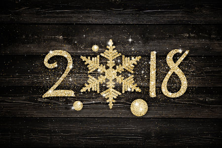 Golden glitter 2018 snowflake over black background. Holiday cardの写真素材