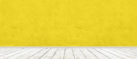Vintage room interior with yellow concrete wall and wood floor background. Wide panorama imageの写真素材