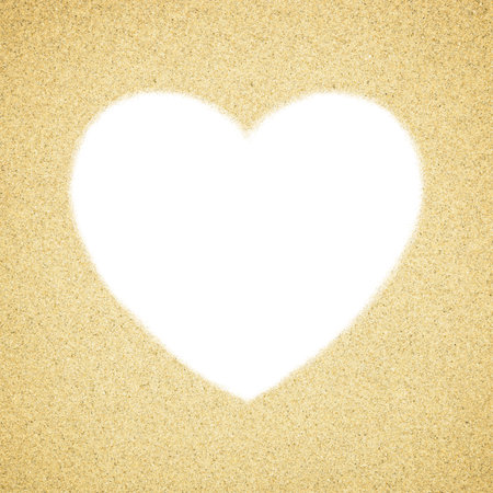 Blank white heart shape in sand background. Close-up of sand grainsの写真素材