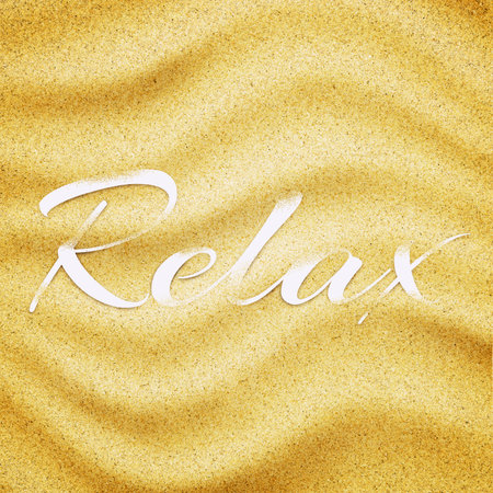 Word RELAX in sand background. Close-up of sand grainsの写真素材