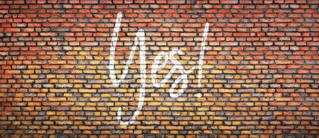Brick wall with word yes. Concept backgroundの写真素材