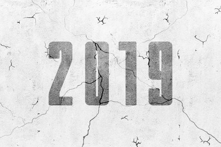 Blank concrete grey wall with crack texture background and 2019 new year inscriptionの写真素材