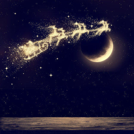 Santa flying on night sky over moon light. Merry Christmas and happy holiday.の写真素材