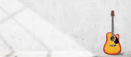Guitar in empty vintage room with white wall backgroundの写真素材