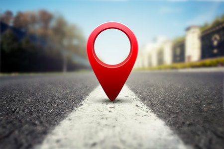 Red GPS pin on asphalt highway backgroundの写真素材