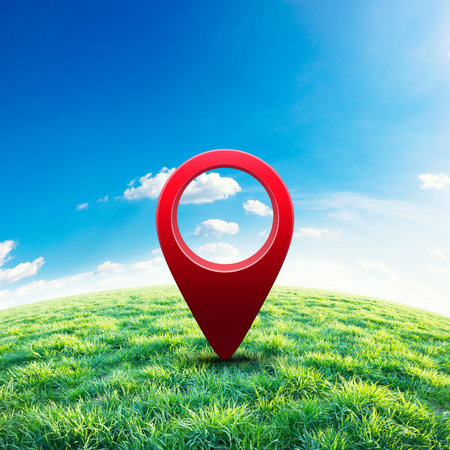 Green field under blue sky with pin location. Abstract concept imageの写真素材