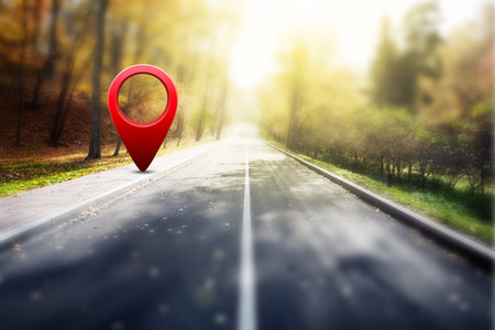 Red GPS pin on asphalt road and beauty autumn natureの写真素材