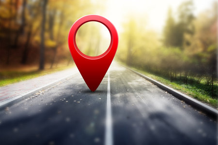 Red GPS pin on asphalt road and beauty autumn natureの写真素材