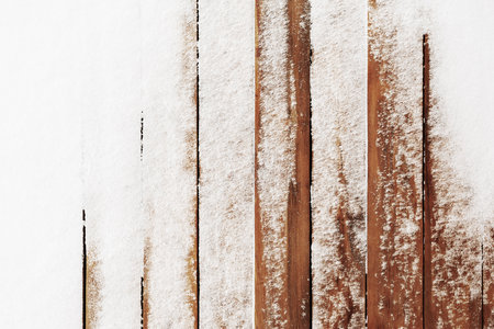 The brown wood texture with snow flakes over it. Winter christmas backgroundの写真素材