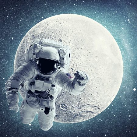 Astronaut in outer space over full moon and stars background.の写真素材