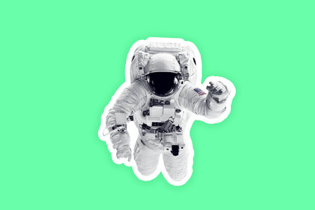 Astronaut in space suit paper sticker over white background.の写真素材