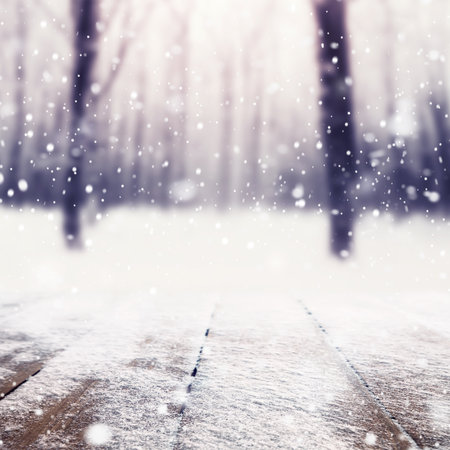 Winter snow covered forest behind wooden tableの写真素材