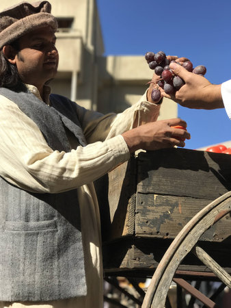 Village Man Bartering Tomatoes for Grapesのeditorial素材
