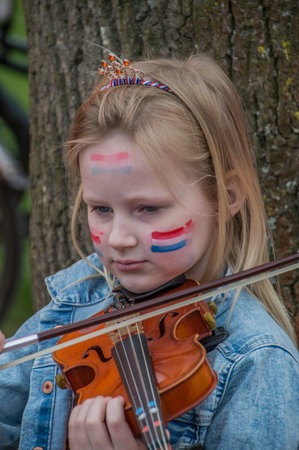 Girl Playing The Violin In The Vondelpark On Kingsday At Amsterdam The Netherlands 2018のeditorial素材