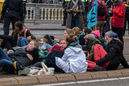 Protesters Holding Together At The Blauwebrug At The Climate Demonstration From The Extinction Rebellion Group At Amsterdam The Netherlands 2019のeditorial素材