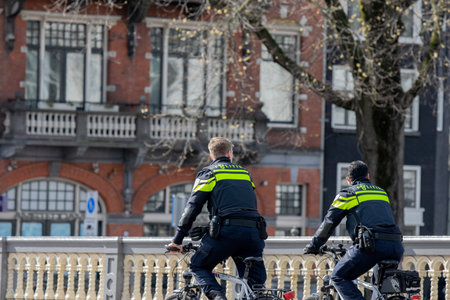 Two Police Men Patrolling During The Corona Virus Outbreak At Amsterdam The Netherlands 2020のeditorial素材
