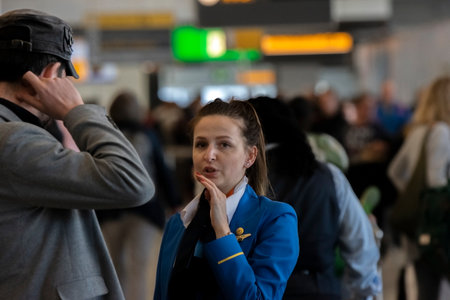 Ground Stewardess Helping Passengers At Schiphol Airport The Netherlands 2019のeditorial素材