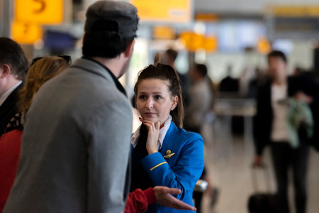 Ground Stewardess Helping Passengers At Schiphol Airport The Netherlands 2019のeditorial素材