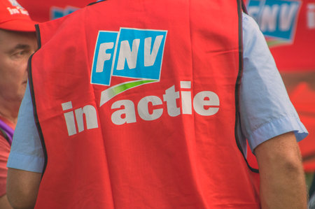 Demonstration Of Trigion Employees For A Better Collective Employment Agreement At The Headquarters Of Trigion Amsterdam The Netherlands 2018. Backside Of A FNV Jacket With The Text FNV In Actionのeditorial素材