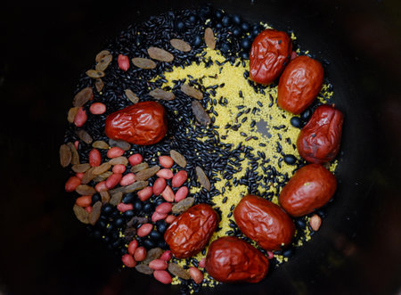 top view of colorful mixed raw cereal and millet in black rounded background.の写真素材