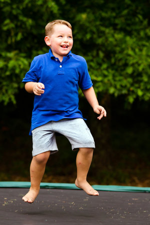 Child playing while jumping on trampoline