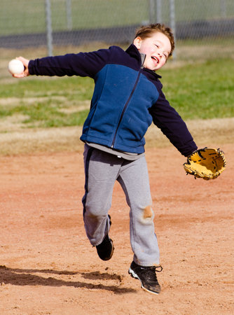Young boy throwing ball during t-ball practice