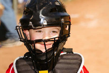 Portrait of child with catcher s equipment on during baseball gameの写真素材