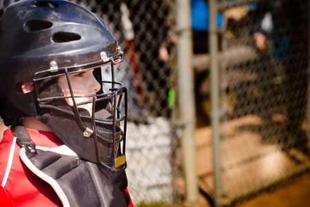 Child playing catcher during baseball game with space for copyの写真素材