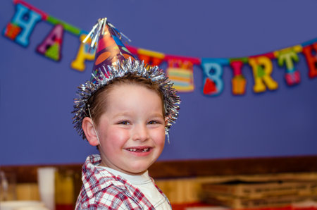 Portrait of child enjoying his birthday party with copy spaceの写真素材