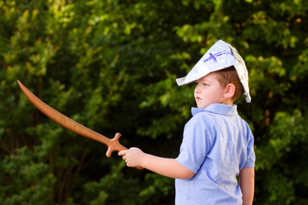Child playing pirate outdoors in homemade costumeの写真素材