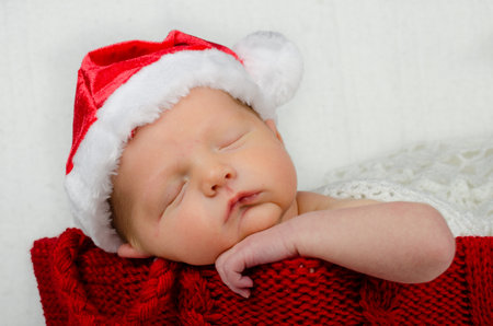 Cute newborn infant wearing santa hat for christmas holidayの写真素材