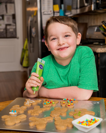 Child decorating ginger bread man
