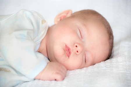Infant baby boy sleeping peacefullyの写真素材