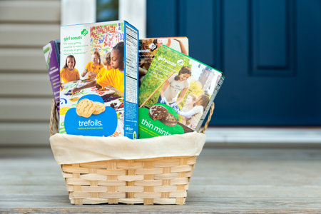 ATLANTA - MARCH 9, 2014  Assortment of packaged Girl Scout cookies in basket delivered on front porch のeditorial素材