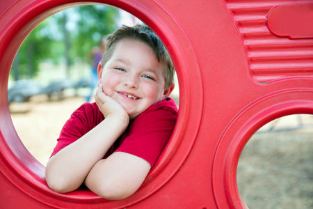 Portrait of young child playing on playground の写真素材