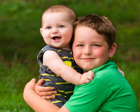 Happy brothers hugging in summer portrait outdoorsの写真素材