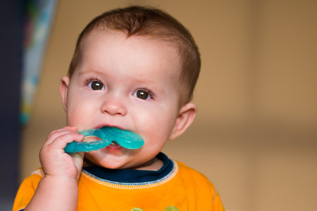 Baby chewing on teething ring toyの写真素材