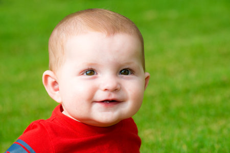 Smiling happy cute baby outdoorsの写真素材