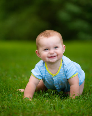 Summer portrait of happy baby boy infant outdoors at parkの写真素材
