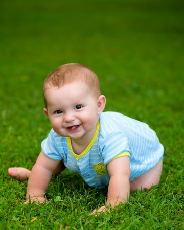 Summer portrait of happy baby boy infant outdoors at parkの写真素材